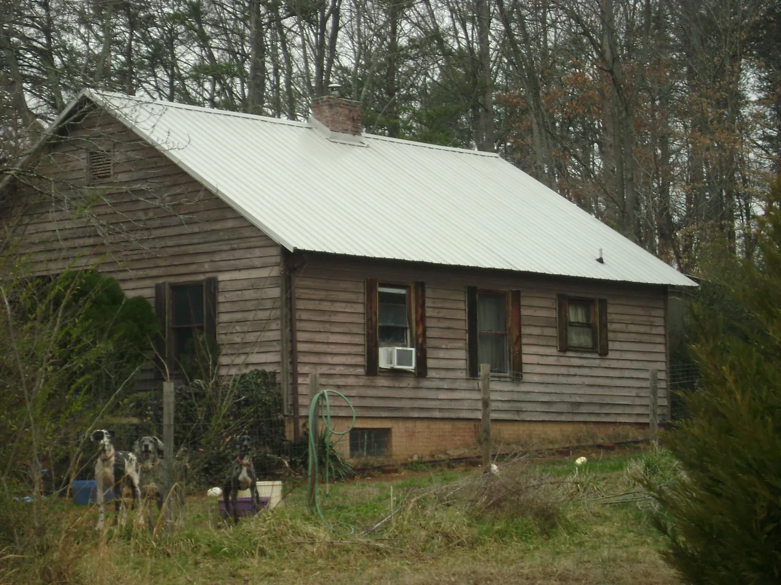 White metal roof on an old wood sided farmhouse, from a Metal Roof Installation job in East Wareham